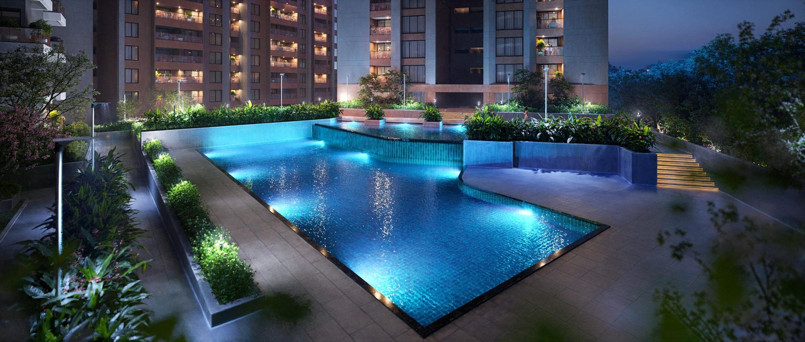 Three modern towers with glass balconies and green surroundings